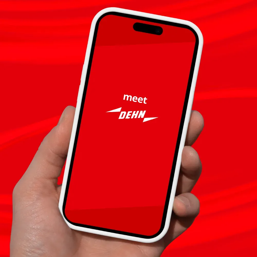 Hand holding smartphone with meet DEHN application